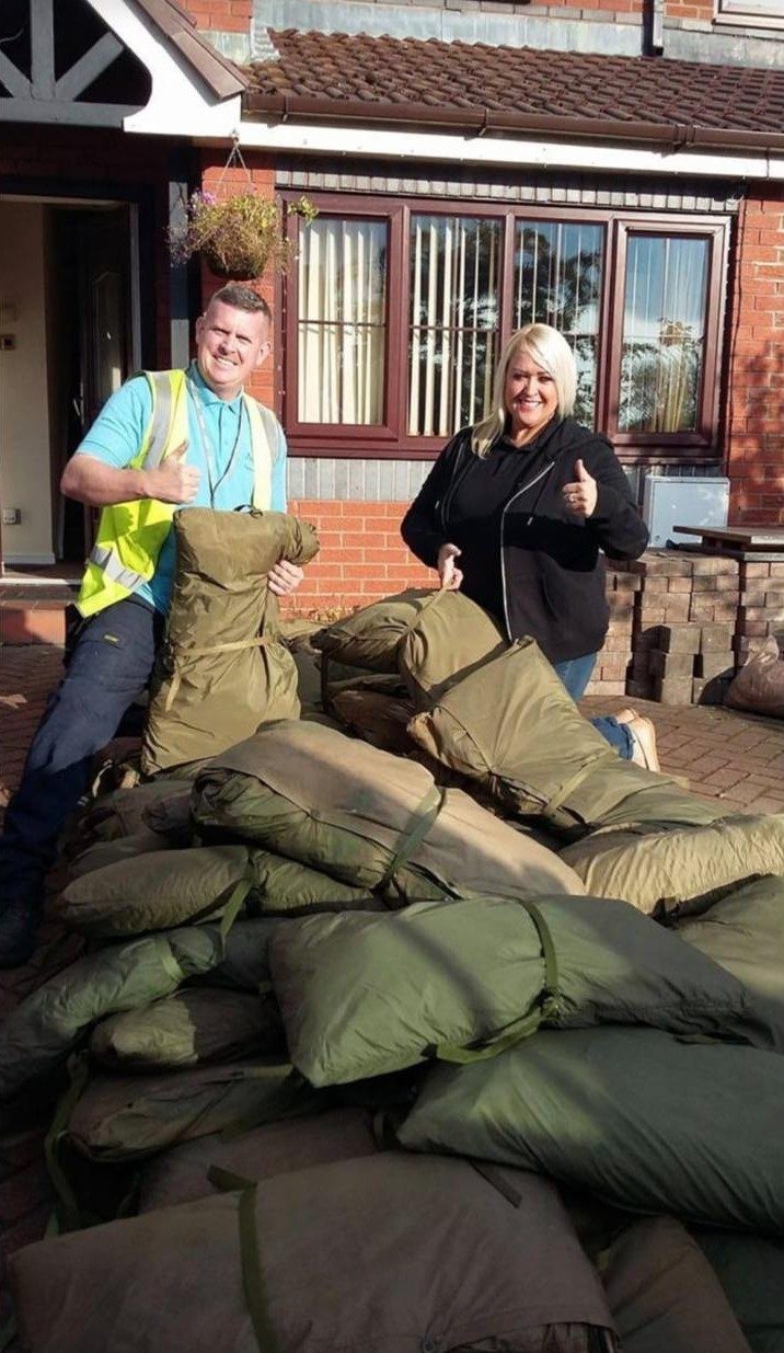 Volunteers with piles of sleeping bags for rough sleepers